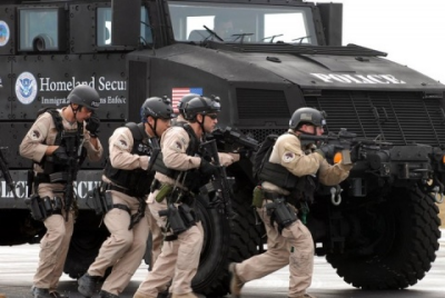 DHS Agents With an Mine-Resistant Ambush-Protected (MRAP) Armored Personnel Carrier