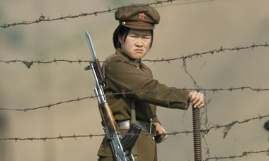 North Korean soldier mans the border with South Korea where nearly 25 million people are held by dictator Kim Jong-Un living in abject poverty